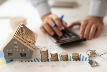  Business and Financial for residence, Money saving for home concept. Increasing coin stacked and house model on the wooden table. Studio shot.