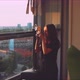 Woman photographer taking a picture from the balcony - VideoHive Item for Sale