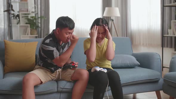 Children With Joystick Game Play Video Game On Tv, Boy Celebrating Victory And Girl Disappointed