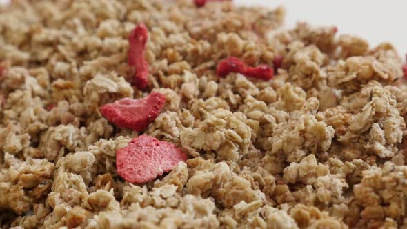 Dried strawberries in muesli breakfast close-up 4K 2160p 30fps UltraHD panning footage - Pile of deh