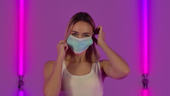 Portrait of Fashionable Model Puts on and Then Removes the Medical Protective Mask