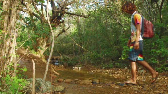 In this video clip you can see young man walking somewhere in jungle forest. This is perfect shot fo