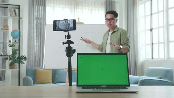 Teacher With Green Screen Laptop Shoots Video By Smartphone Camera While Teaching Math At Home