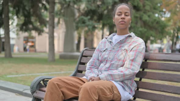 African Woman Standing and Leaving After Sitting on Bench Outdoor