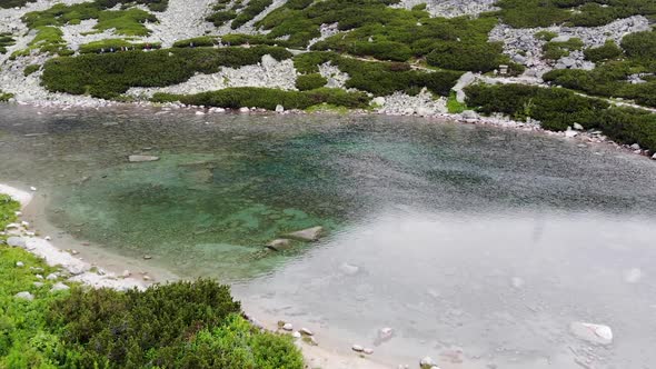 AERIAL: Mountain Lake with Clear Turquoise Water