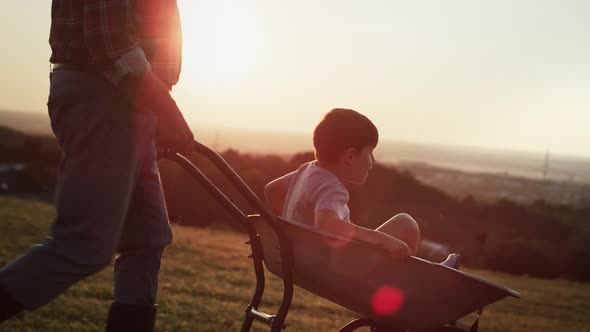 Video of boy having fun during driving on a wheelbarrow.  Shot with RED helium camera in 8K.