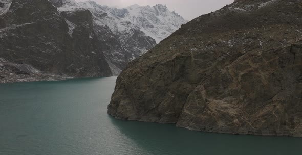 Aerial Dolly Reveal Of Wilderness Landscape Surrounding Attabad lake In Hunza Valley. Establishing S