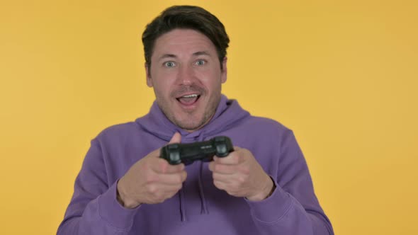 Man Playing Video Game, Yellow Background 