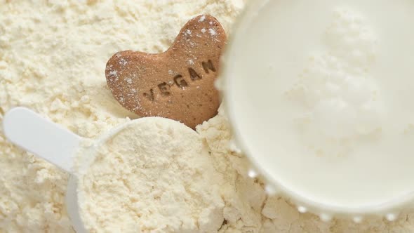 Protein powder and measuring scoop over the jar