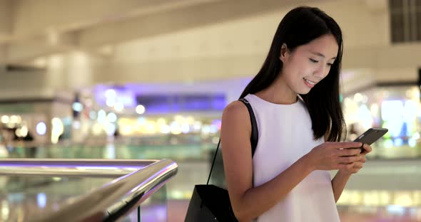 Young woman looking at smart phone 
