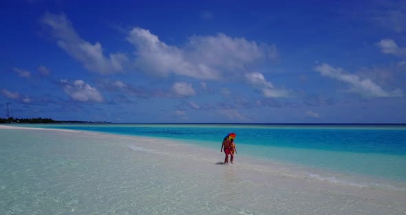 Beautiful lady and man on romantic honeymoon enjoy life on beach on white sand background 