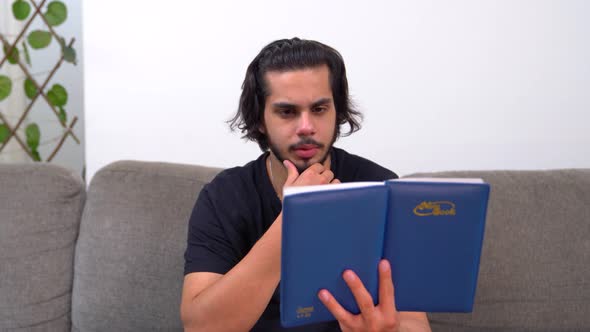 Indian man reading a book