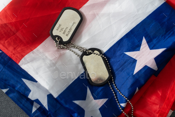 Soldier's token on American flag background.