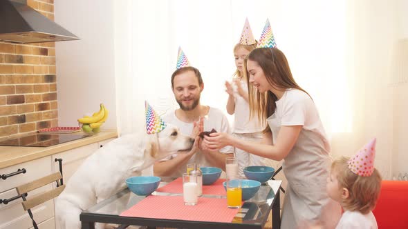 Happy Birthday Funny Dog and Careful Owners in the Kitchen