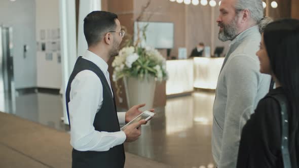 Male Concierge Welcoming Customers in Hotel