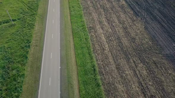 Aerial Motion Over Ploughed Field Meadow Separated By Road