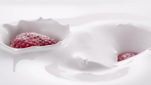 Strawberries Falling Into Thick White Cream