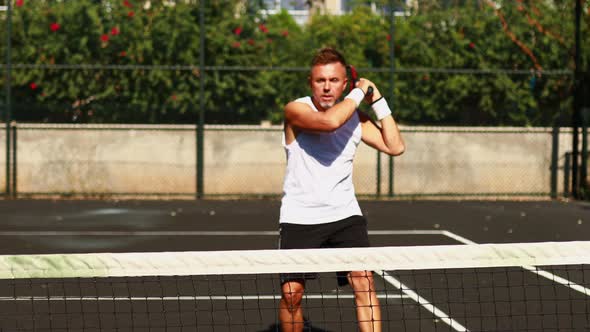 Senior Caucasian Man Playing Tennis on Court Holding Tennis Racket Day Light Outdoors on Fresh Air