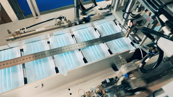 Face Masks Moving Along a Conveyor at a Modern Face Mask Factory