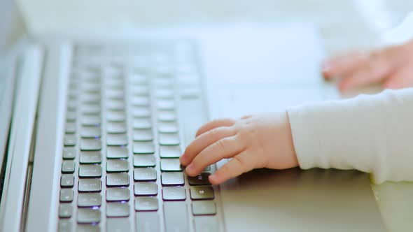 Close Up of a Baby Hands of Typing on a Laptop