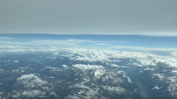 Aerial side view from a jet cockpit. Pilot pov, from the italian Alps mountains during cruise level