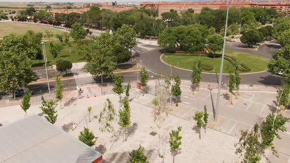 Few cars driving around roundabout in Spain, aerial fly over view