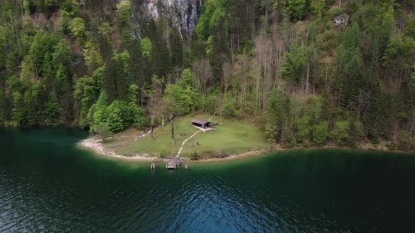 Cabin by the alpine lake drone aerial view