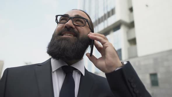 Happy Businessman Talking on Phone and Smiling Satisfied With Good Business News