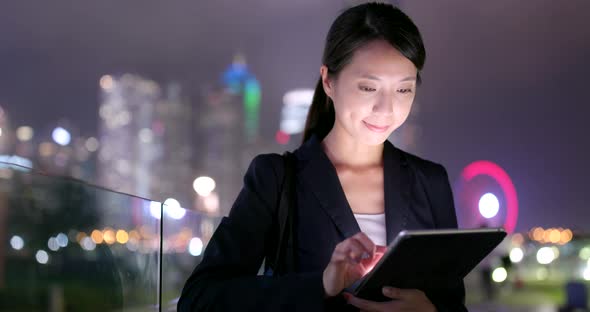Asian Businesswoman use of tablet computer at night