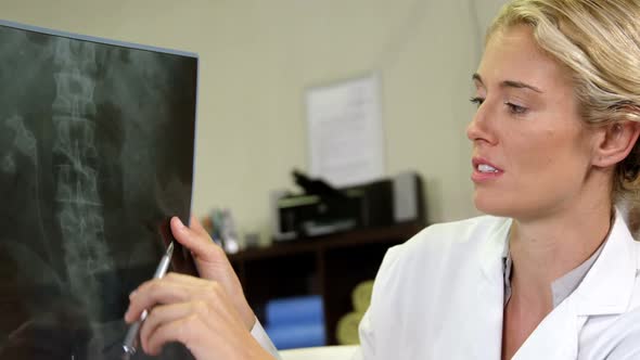 Physiotherapist showing x-ray to a patient