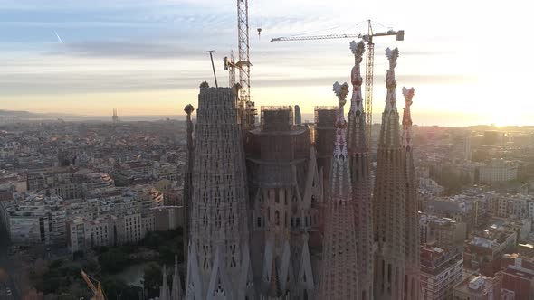 Aerial panning shot from the façade of the Sagrada Familia to the cityscape of Barlelona