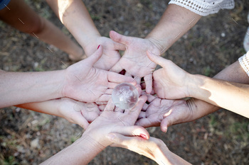 group of people joining hands