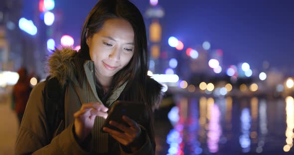 Young Woman Use of Smart Phone in City at Night