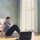 Woman Does Abdominal Exercises Near Laptop in Living Room - VideoHive Item for Sale