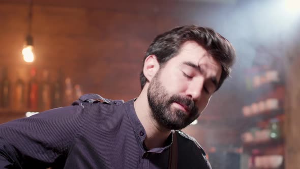 Close-up Portrait of a Bearded Man Singing a Song