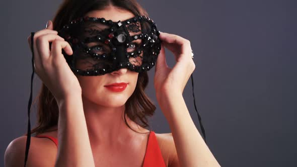 Beautiful woman wearing masquerade mask 4k