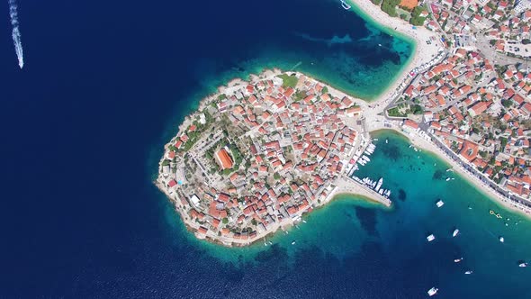 Aerial view of speedboat passing Primosten peninsula, Croatia