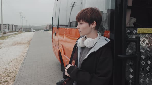 Portrait of Teenage Girl Next to School Bus