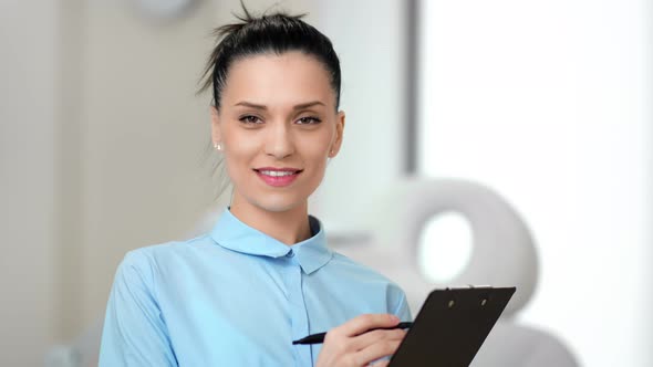 Portrait of Smiling Young Female Doctor Pleasure Working at Modern Clinic Medium Closeup