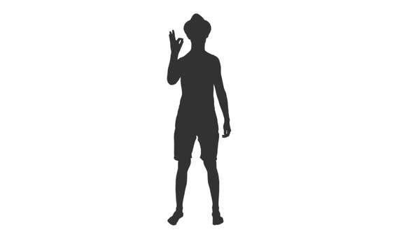 Silhouette of Young Shirtless Man in Shorts and Hat Showing OK Sign