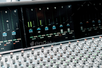 A large mixing console in a recording studio close-up of an equalizer multi-channel sound recording