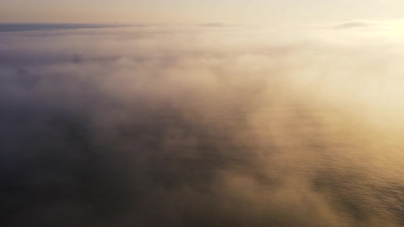 Aerial shot of  sea in foggy day with cargo ships