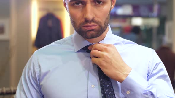 Man Tying a Tie at Wardrobe