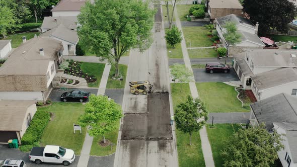 Aerial Drone View of Road Repairs in the Suburbs on the Street with Many Houses