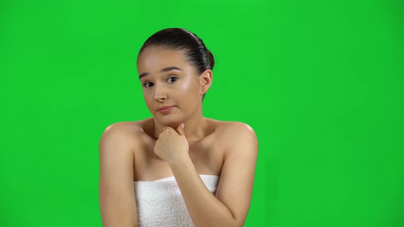 Young Girl in White Towel Thinks About Something, and Then Shrugs, No Idea, Green Screen