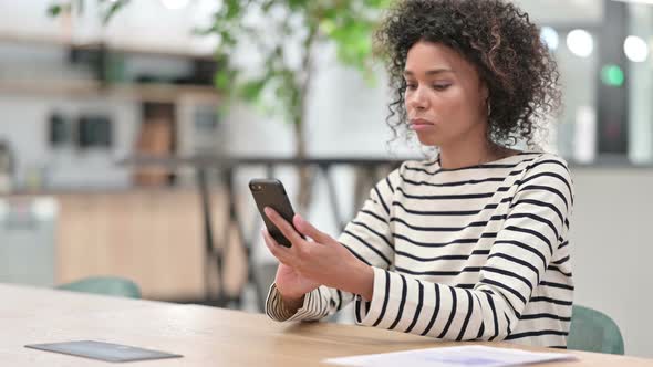 African Woman Using Smartphone in Office