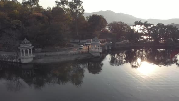 Road along Pichola lake, Udaipur. Amazing architecture and nature.Sunbeam during sunset.