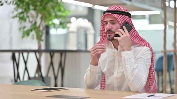 Cheerful Arab Businessman Talking on Smartphone