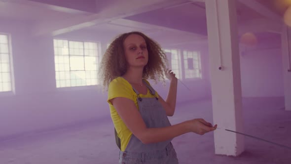 Fashionable young woman in an abandoned warehouse