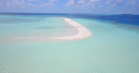 Beautiful flying clean view of a summer white paradise sand beach and blue ocean background in color